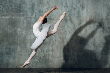 Plakat Jumping ballerina . Young beautiful woman ballet dancer, dressed in professional outfit, pointe shoes and white tutu.