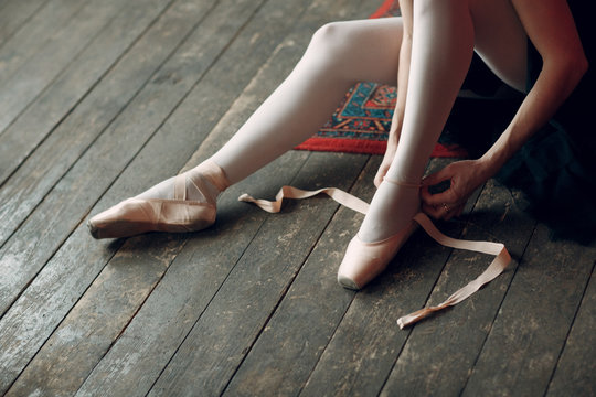 Ballerina prepare to performance. Young beautiful woman ballet dancer, dressed in professional outfit, pointe shoes and black tutu.