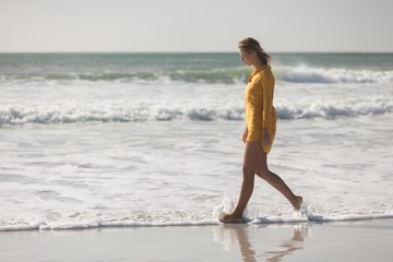 Woman walking on the beach near seashore