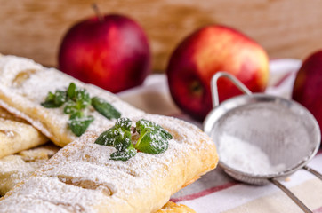 Fresh puff pastry pies stuffed with apples and cinnamon