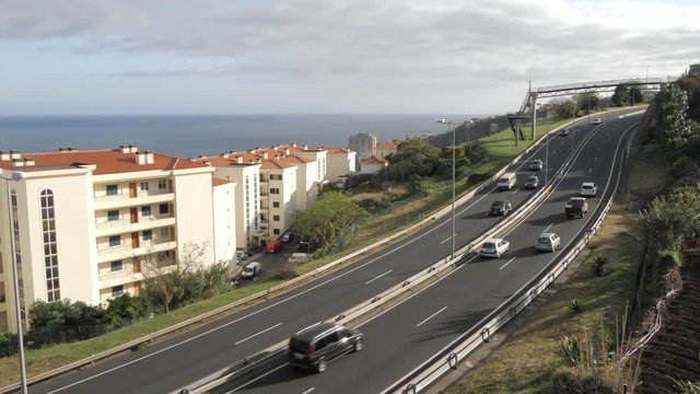 Pan shot of VR1 road near Canico and Atlantic Ocean visible in background, Madeira, Portugal, Atlantic, Europe
