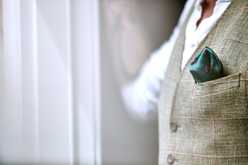 man in waistcoat with green pocket square
