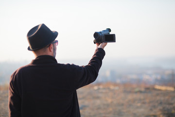 vlogger explaining while recording himself with camera