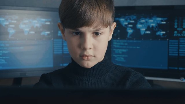 Genius boy wonder hacks system at cyberspace. Cute kid young programmer working on computer at data center.