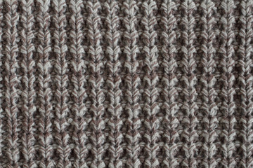 White with brown melange woolen knitted fabric texture. Macro.
