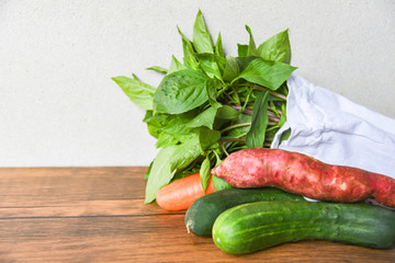 Zero waste use less plastic say no plastic bag concept / Fresh vegetables organic in eco cotton fabric bags on wooden table