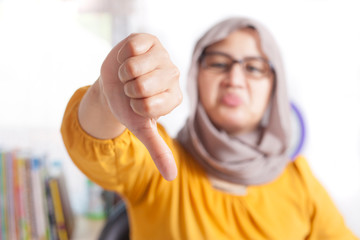 Muslim Woman Thumbs Down, Dissapointed Expression