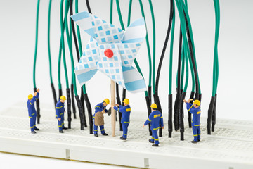 Sustainable energy, alternative clean eco power concept, miniature people worker help building...