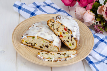Baked cake with raisins and candied fruits, sprinkled with powdered sugar