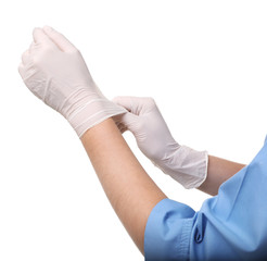 Female doctor putting on rubber gloves against white background, closeup. Medical object