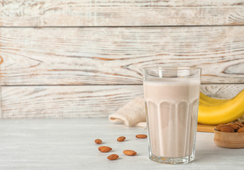Composition with glass of healthy protein shake on table. Space for text
