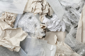 Pile of paper and plastic garbage as background, top view. Recycling problem
