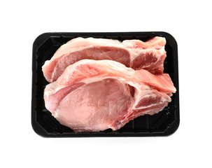 Plastic container with raw steaks on white background, top view. Fresh meat