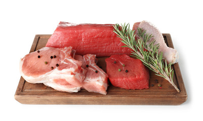 Board with various raw meats and spices on white background
