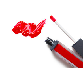 Red liquid lipstick with smear and applicator isolated on white, top view