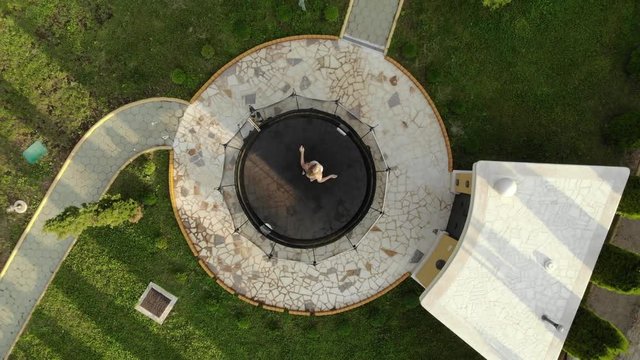 A drone video of a girl jumping on a trampoline in 4K