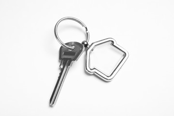 House key with trinket on white background