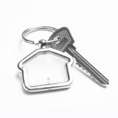 House key with trinket on white background
