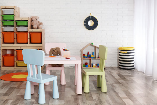 Modern child room interior with table and chairs