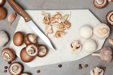 Flat lay composition with fresh champignon mushrooms on table