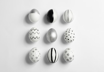 Painted Easter eggs on white background, top view
