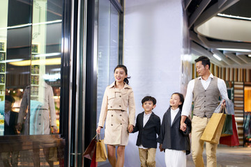 asian family walking in shopping mall