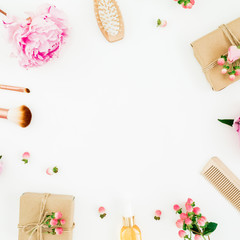 Creativity frame composition of pink peony with hairbrush, tassel and gifts box on white background. Flat lay, top view