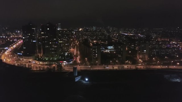 night aerial view on panorama of amazing megapolis with lights in windows of high buildings