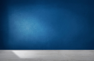 Dark blue wall in an empty room with a concrete floor