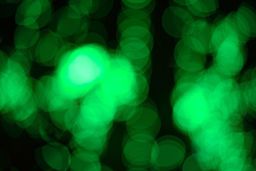 Obraz premium Abstract green bokeh on black background and lights at night picture