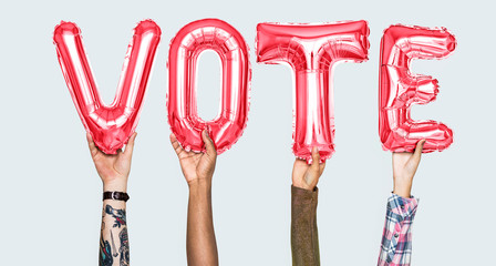 Hands holding vote word in balloon letters