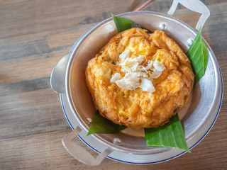 Tasty Thai style omelette with crab meat on top in pan