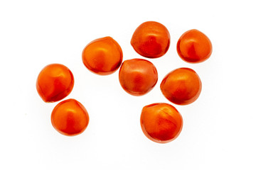 Red seeds of adenanthera pavonina. on white background