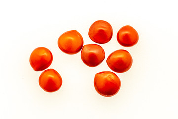 Red seeds of adenanthera pavonina. on white background