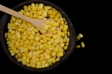 corn in a ceramic vessel and clay in the bottom of kitchen