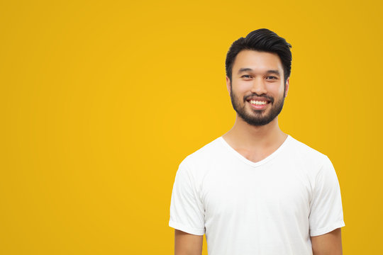 Asian Handsome Man With A Mustache, Smiling And Laughing Isolated On Yellow Background