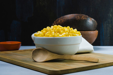 corn in a ceramic vessel and clay in the bottom of kitchen