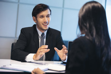 Businessmen and Businesswomen discussing documents for job interview concept