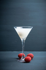 Sweet lychee martini on the rustic background. Selective focus. Shallow depth of field.