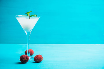 Sweet lychee martini on the rustic background. Selective focus. Shallow depth of field.