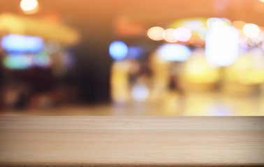 Empty dark wooden table in front of abstract blurred bokeh background of restaurant . can be used for display or montage your products.Mock up for space.