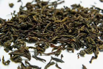 Leaf tea lies on a white background. Leaf tea storage. Natural product. Weighted green tea. Packing...