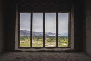 Empty window looking out into the landscape scenery of Leh Ladakh