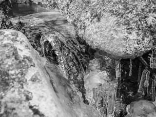 ice water flowing over rock closeup