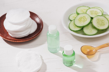 Cosmetic bottle and fresh organic cucumber for skincare. Home spa concept.