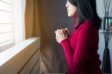 Asian woman with hand in praying position,Female prayer hands clasped together