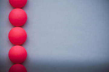 Red pills in a row on a blue background.