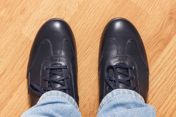 Navy blue leather shoes for men on wooden background