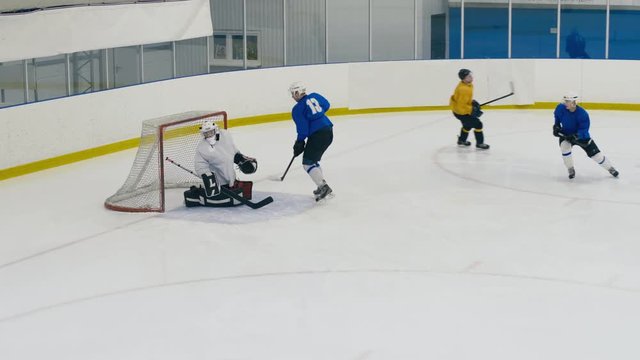 High angle shot of offensive zone in ice hockey game, when professional player shooting a goal to goalie