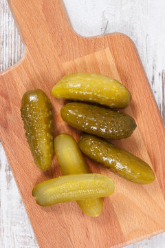 Fresh prepared homemade pickled cucumbers on cutting board, healthy addition to meal